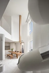 Modern minimalist interior with white marble flooring, wooden furniture, and high ceilings.
