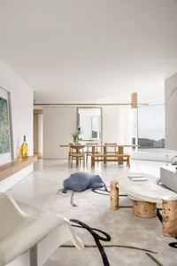 Modern living room interior with marble accents, minimalist design, and natural light.