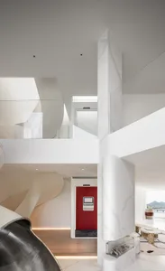 A modern living room featuring a contemporary design with marble accents and concrete elements.
