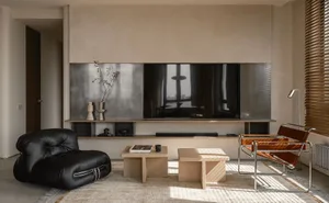 Minimalist living room featuring neutral-toned furniture and decor