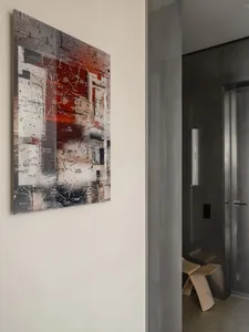 A contemporary abstract piece with mixed media techniques, including red and beige tones.