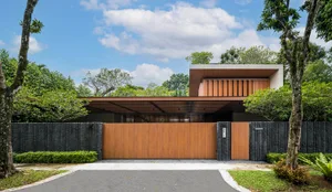 A contemporary residential house with wooden accents and concrete walls.