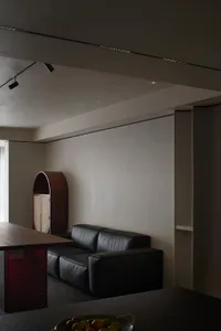 Black leather sofa against a wall in a modern residential interior