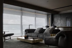 Modern living room with a metal coffee table, leather sofa, and stone accents.