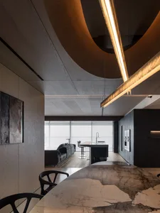 A modern open-concept living room featuring a dark wood and concrete ceiling with curved lines, a large window, and a black s