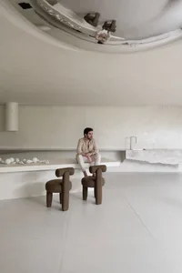 A minimalist residential interior with concrete flooring and minimalist furniture.