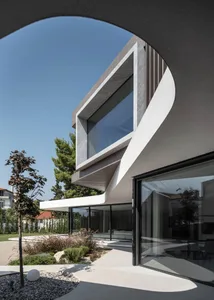 A modern house with concrete and glass exterior materials.