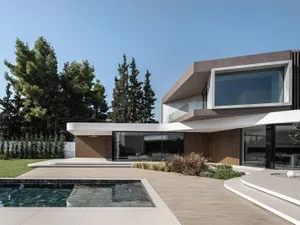 A modern house featuring a sleek concrete and glass exterior.