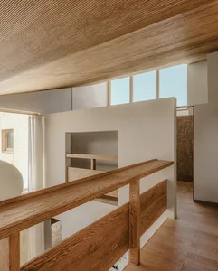 Modern minimalist loft interior with wooden railings and concrete walls