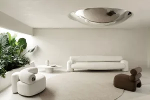 A modern white living room with concrete accents and minimalist furniture.