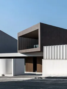 A minimalist house with concrete and wooden exterior.