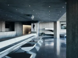 Modern, industrial-style interior with concrete walls and floors, featuring sleek, minimalist furniture and a dramatic, monoc
