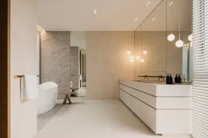 Modern minimalist bathroom featuring stone surfaces and minimalistic design.