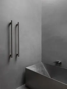 Modern, industrial-style bathroom with concrete walls and minimalist design elements.