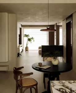 Modern minimalist living room with concrete floor, wooden furniture, and marble accents.