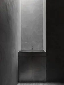 A sleek, modern concrete sink integrated into a minimalist bathroom design.
