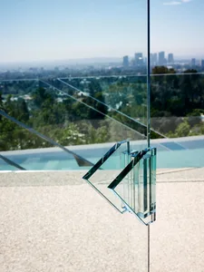 A modern glass exterior with a minimalistic design featuring glass panels and structural glass elements.