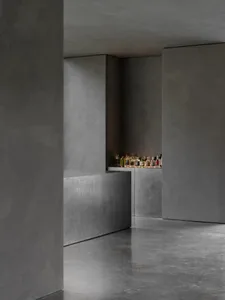 Modern industrial-style bar counter made of concrete, featuring a sleek design with a minimalist aesthetic.