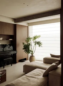 A modern living room featuring minimalist furniture, wood accents, a piano, a large house plant, and large windows allowing n