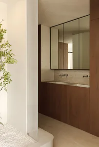 Modern minimalist bathroom with wooden cabinets and ceramic tile accents.