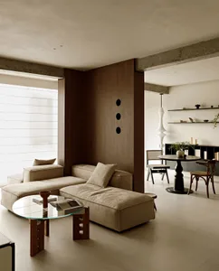 A modern living room with neutral tones and minimalist furniture.