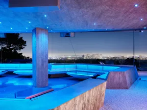 A modern roof deck with concrete features and a cityscape view.