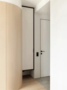 Modern minimalist interior with natural materials, including light-colored wood, concrete, and glass.