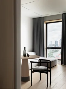Minimalist residential interior featuring a modern round table made of wood.