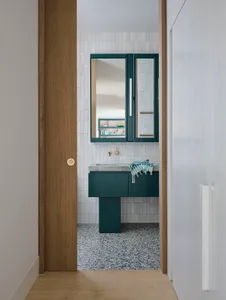 A modern bathroom featuring a minimalist design with gray terrazzo tiles on the floor and walls.