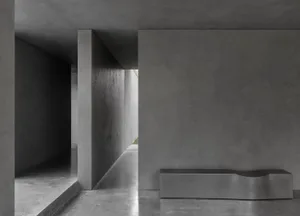 Concrete walls and floor of a modern industrial interior space.