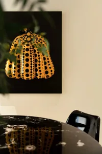 A minimalist interior designed with a polka dot pumpkin sculpture.