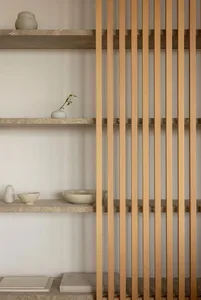Sleek, minimalist shelf display featuring natural materials and simple decor.