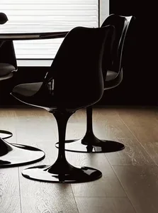 Modern, minimalist black chairs with polished finish in a contemporary interior design setting.