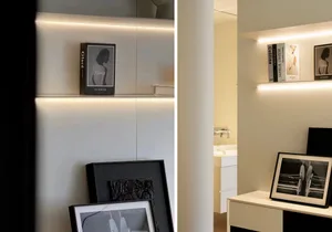 A modern bookshelf with glass shelves illuminated from the back against a white wall.