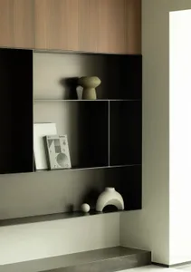 A modern interior design featuring black shelving with minimalist decorations and a clean, contemporary style.