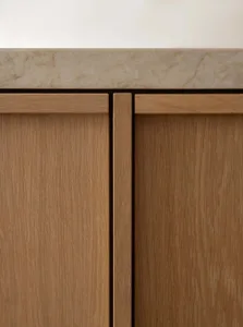 Close-up of a modern minimalist cabinet made of oak wood.