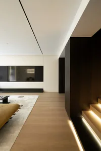 Modern minimalist living room featuring wood, glass, and metal elements.