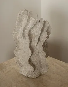A textured ceramic sculpture with organic forms.