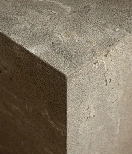 A modern interior design featuring concrete surfaces and minimalist aesthetics.
