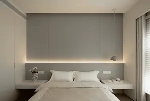Modern minimalist bedroom with white bed and neutral tones