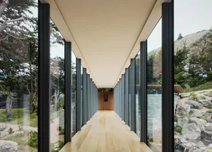 A modern interior hallway with glass walls and concrete columns, leading to a wooden floor and a view of the outdoors.
