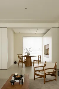 A modern residential living room featuring natural wood furniture and minimalist design.