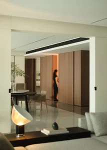 A modern residential interior featuring wooden and marble elements.