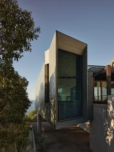 Modern residential house with metallic and glass exterior features, designed for elegance and style.