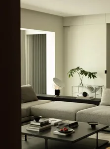 Modern living room with textured fabric sofas, a low coffee table, and a minimalist design.