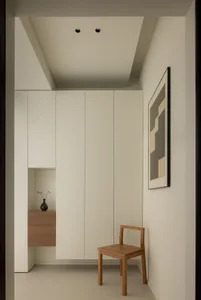Minimalist living room with neutral tones and a wooden chair.