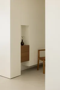 A minimalist interior featuring concrete and wood materials.