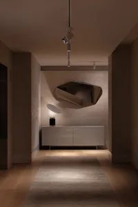 Modern entryway featuring a metallic sculpture as a focal point.