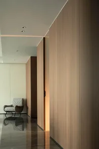 A minimalist interior design featuring wood paneling and marble flooring