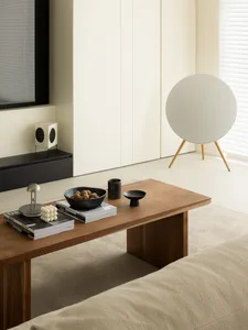 A minimalist living room featuring a wood coffee table and a concrete wall cabinet.